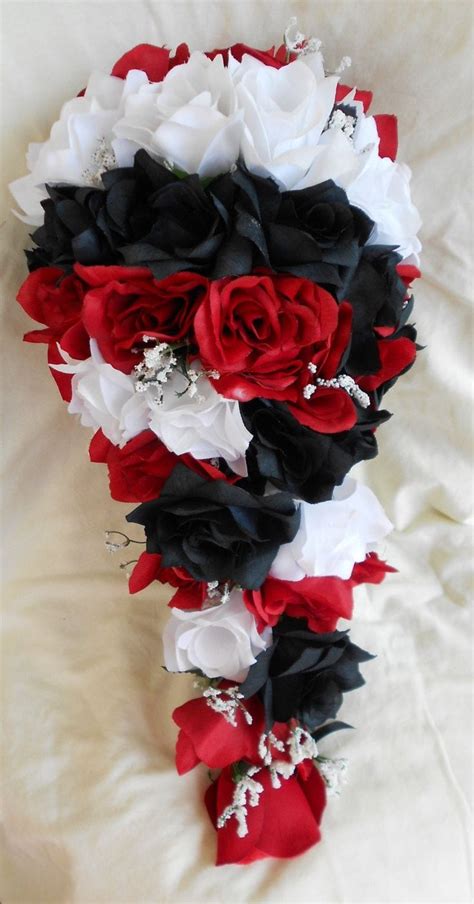 A Bridal Bouquet With Red White And Black Flowers