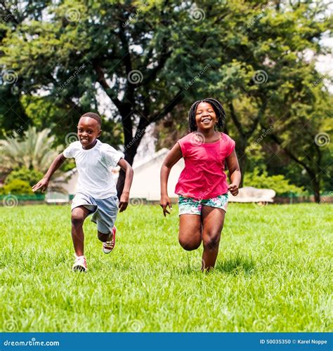 African Kids Running Together In Park Stock Photo Image Of Chase