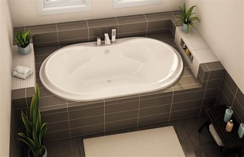 A whirlpool tub is the very essence of luxury and comfort. Oval tub with tap on side, as drop-in with tile surround ...
