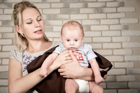 Beautiful Woman With A Baby In Her Arms Studio Photo Stock Image