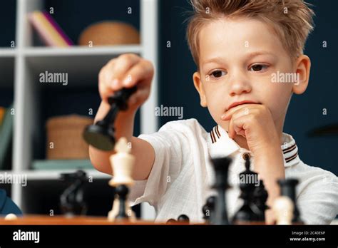 Close Up Photo Of A Little Boy Playing Chess Stock Photo Alamy
