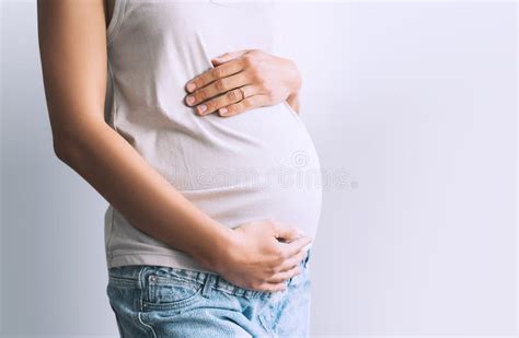 Pregnant Woman Holds Hands On Belly Photo Of Pregnancy Stock Photo