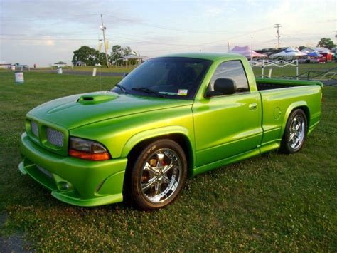 A Bright Green Pick Up Truck Parked In The Grass