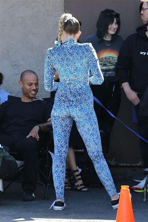 Miley Cyrus In A Blue Floral Jumpsuit On Set Of Her Latest Project In
