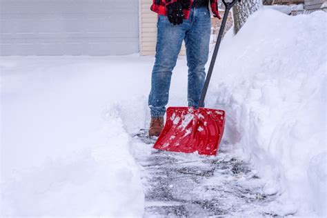 Man Shoveling Deep Snow By Hand With A Red Shovel Stock Photo Image