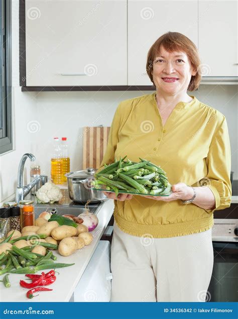 Smiling Mature Woman Cooking Okra Stock Photo Image Of Cooking