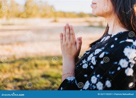 Unrecognizable Believer Person With Praying Hands At Sunset In The