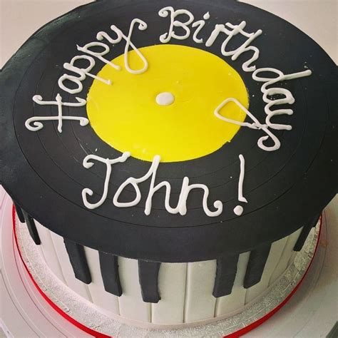 A Birthday Cake For A Music Lover With Piano Keys Around The Edge And A Vinyl Record On Top