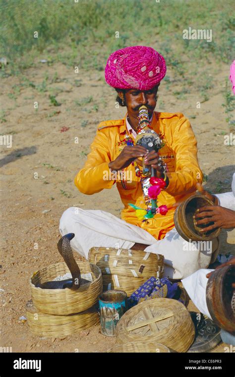 Indian Snake Charmer Charming Serpent With Musical Instrument Pungi