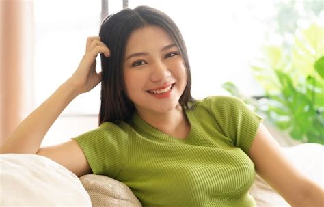 Premium Photo Portrait Of A Happy Asian Woman Relaxing At Home