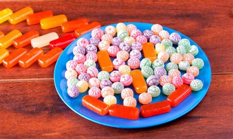 Variation Of Colorful Hard Candy Lying On Blue Plate Stock Photo