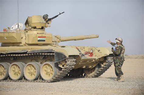 An Iraqi Officer Directs A T 72 Tank To The Firing Line Poster Print