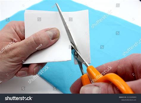 Hands Cutting Paper Scissors Stock Photo 2115245693 Shutterstock