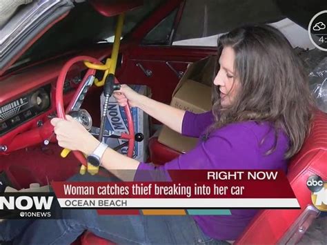 woman catches thief breaking into car
