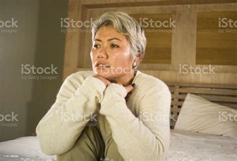 Desperate 40s 50s Mature Lady Dramatic Lifestyle Home Portrait Of Attractive Sad And Depressed