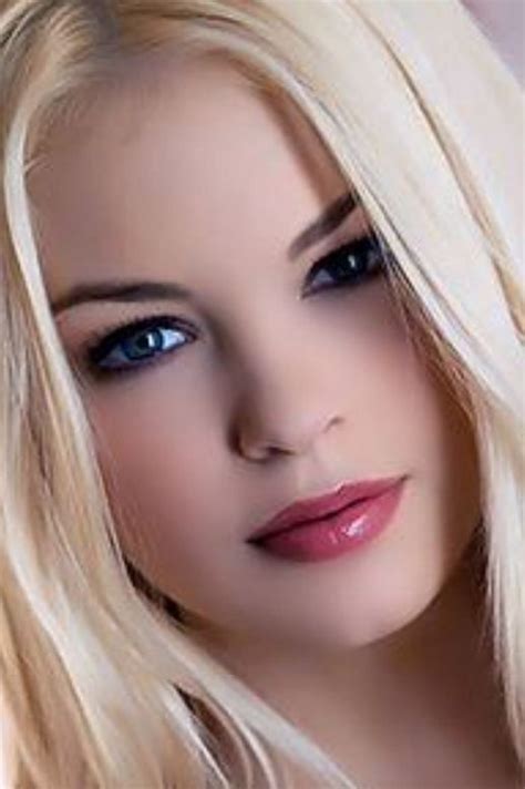 A Woman With Long Blonde Hair And Blue Eyes