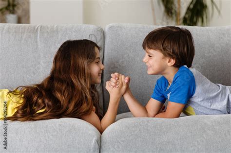 Kids Arm Wrestling On Couch Buy This Stock Photo And Explore Similar