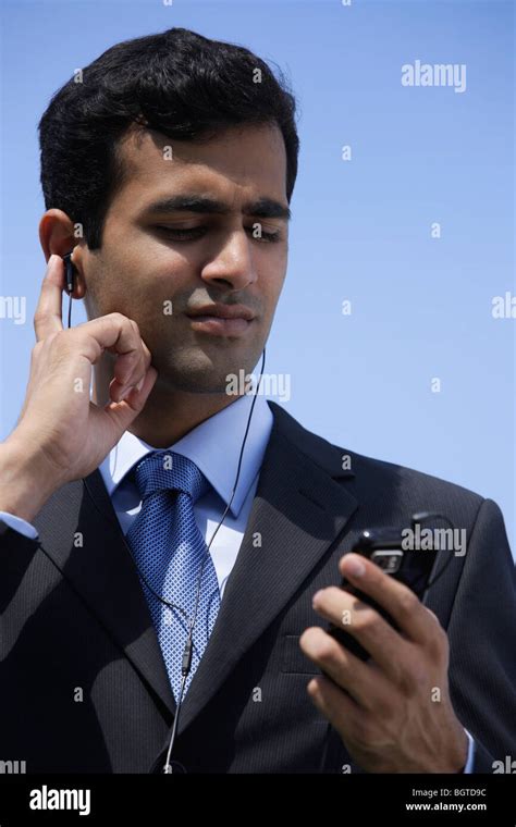 Indian Businessman Listening To Music Outside Stock Photo Alamy
