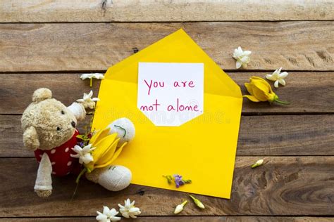 You Are Not Alone Message Card Handwriting In Yellow Envelope Stock