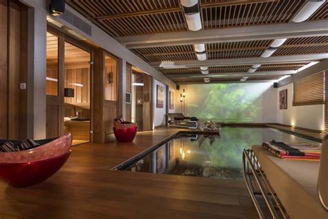 An Indoor Swimming Pool Surrounded By Wooden Flooring And Ceiling
