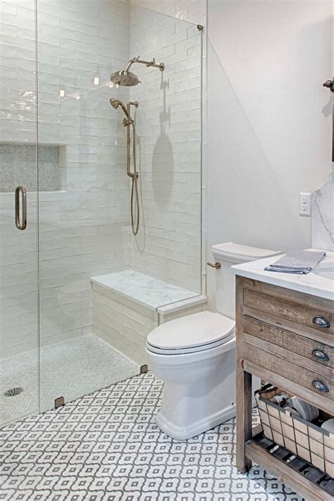 A Bathroom With A Walk In Shower Next To A White Toilet And Wooden Sink Vanity