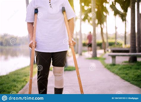 Patient Elderly Asian Woman Using Crutches Support Broken Legs For