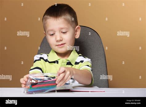 Little Boy Child Kid Drawing With Color Pencils On Brown Background