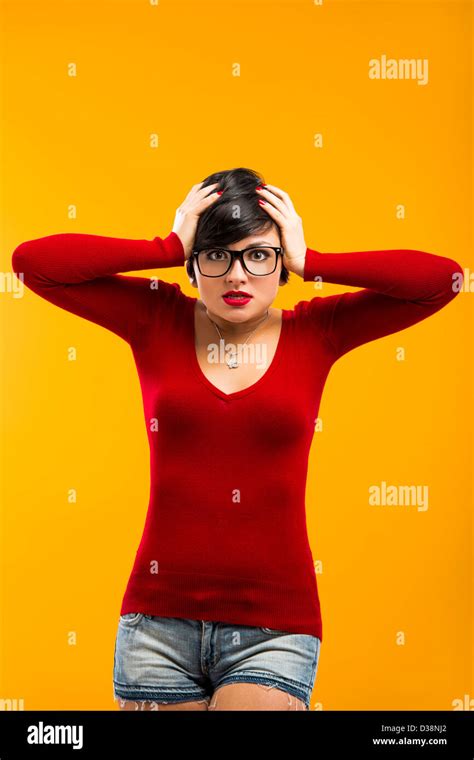 Nerd Girl Angry With Something Against A Yellow Background Stock Photo