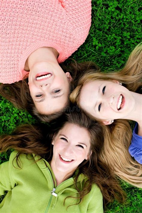 Three Girls Lying On The Grass Stock Image Image Of Park Carefree