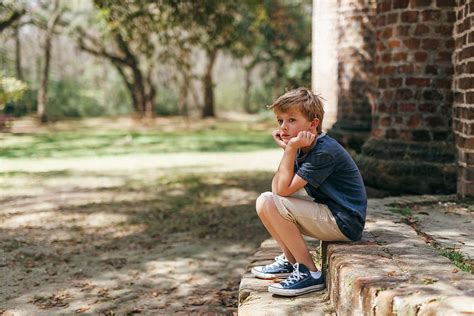 Bored Boy Sitting Alone At A Park By Stocksy Contributor Kelly Knox