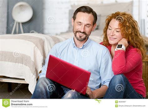 Optimistic Middle Aged Couple Using Laptop At Home Stock Image Image