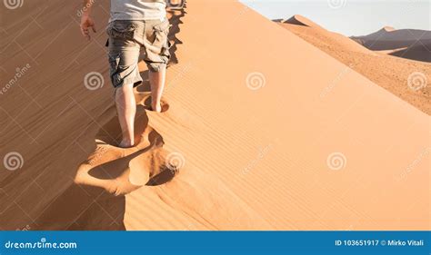 Lonely Man Walking On Sand Crest At Dune 45 In Sossusvlei Desert Stock