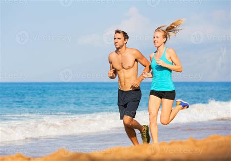 Couple Running On The Beach Stock Photo At Vecteezy