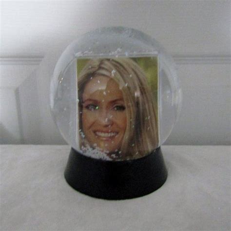 A Snow Globe With An Image Of A Womans Face In The Glass Dome
