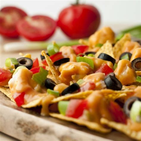 To build the nachos, layer the chips, cheese, and shredded chicken on a dish in several layers, ending with a small layer on top. Chicken Nachos