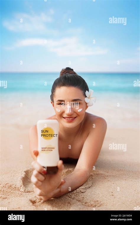 Beauty Woman In Bikini Holding Bottles Of Sunscreen In Her Hands Skincare A Beautiful Female