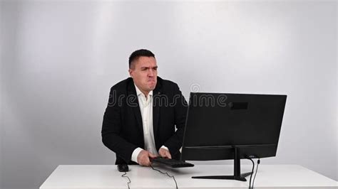 The Man Gets Angry And Smashes The Keyboard On The Monitor An Office