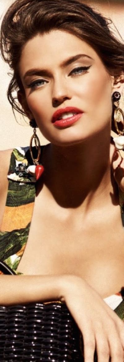 A Woman With Red Lipstick And Large Earrings
