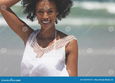 Beautiful Mixed Race Woman Smiling And Looking At Camera On The Beach