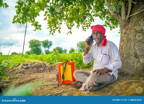 Indian Farmer Talking Mobile Phone At Agriculture Field Stock Image