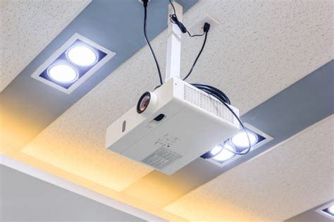 However, a projector hanging from a drop ceiling offers a better throw distance, looks more professional, and will likely last longer, than a countertop projector which is in harm's way. Multimedia projector hanging on the ceiling of modern ...