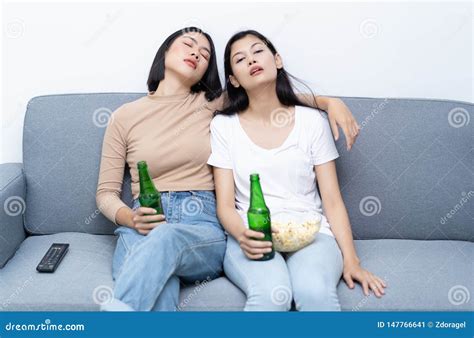 Drunk Lesbian Couple Young Asian Woman Sitting On The Sofa In