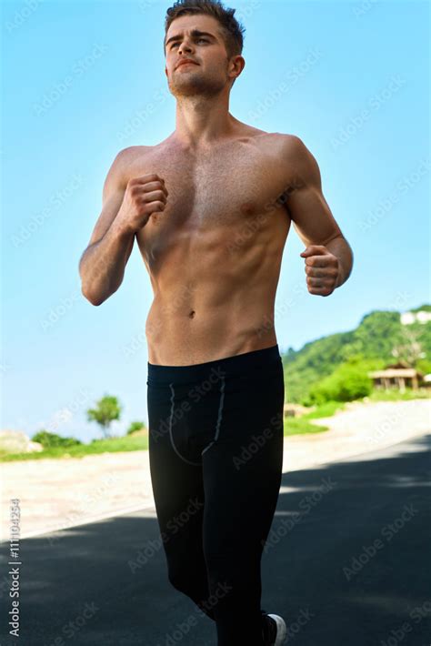 Sport Topless Handsome Athletic Man With Fit Muscular Body In Sportswear Running On Road