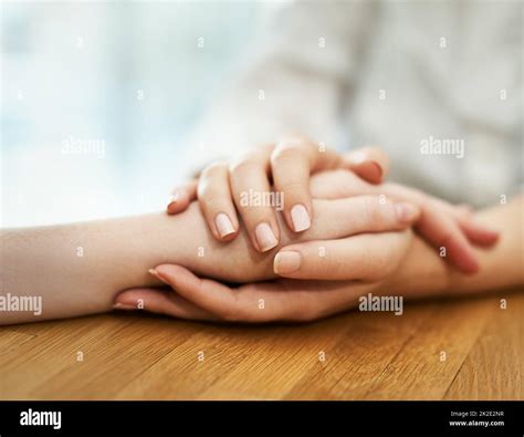 Offering Support And Comfort Shot Of Two People Holding Hands In