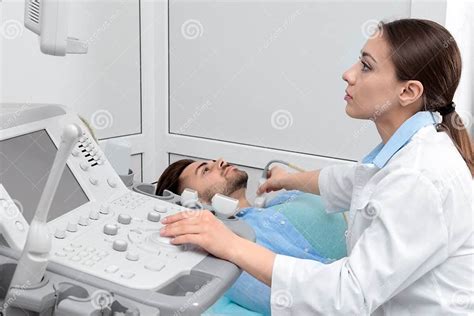 Doctor Conducting Ultrasound Examination Of Patient S Neck Stock Image