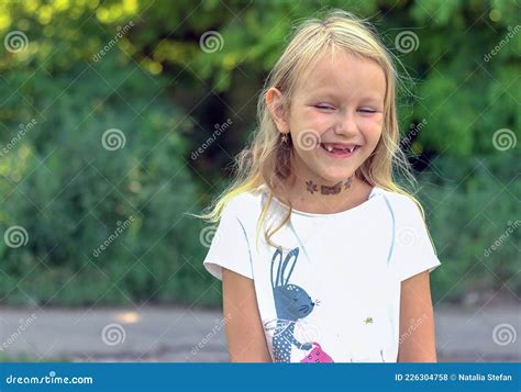 Girl 6 Years Old Blonde Hair Smiling With A Toothless Mouth Stock