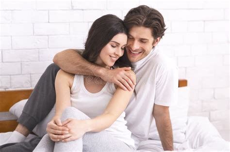 Young Loving Couple Having Romantic Times In Bedroom Stock Photo