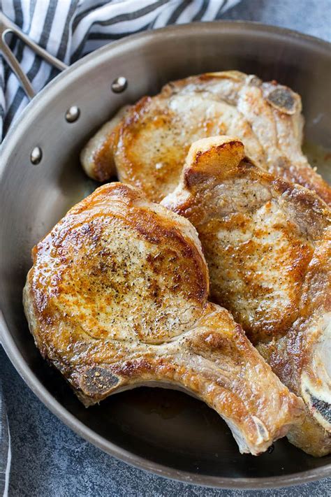 Quite simply the best boneless pork chops i've ever made. Browned bone in pork chops in a frying pan. | Pork chop ...