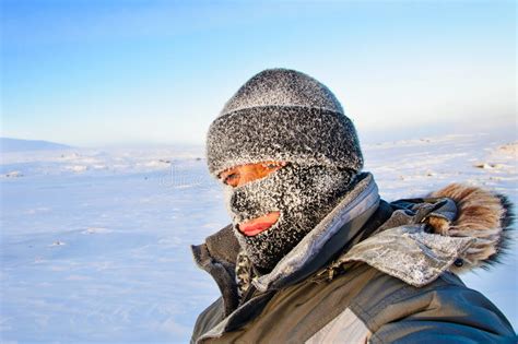 Portrait Of A Man In A Cap And A Ski Mask Stock Photo