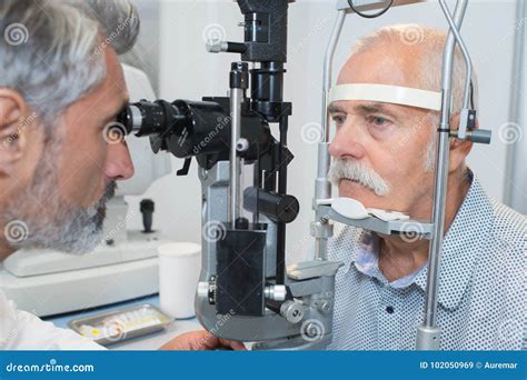 Senior Taking Eye Test Examination At Opticians Stock Image Image Of